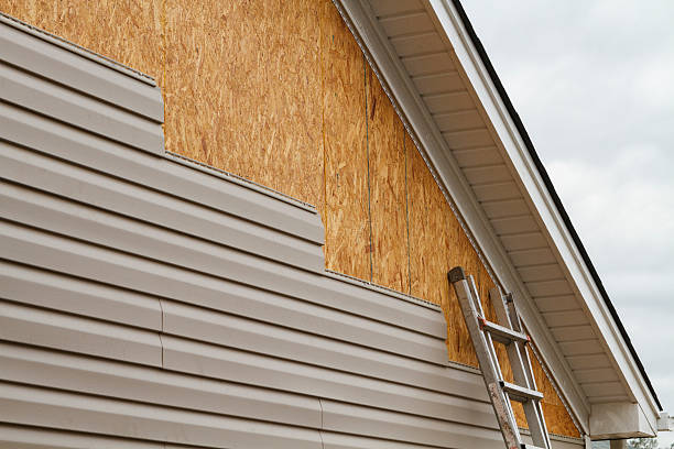Professional Storm Damage Siding Repair technician working in Belmont, OH